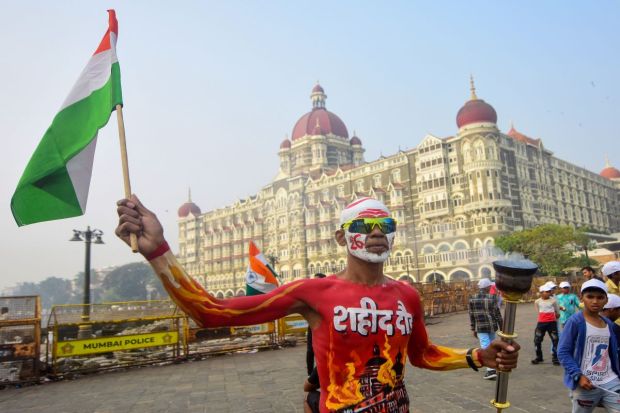 A man with body painted takes part in the Mashaal Rally organised by Maharashtra Police Boys Sanghatana to pay tribute to the 26/11 terror attack victims on its anniversary, outside Gateway of India, in Mumbai. (PTI)