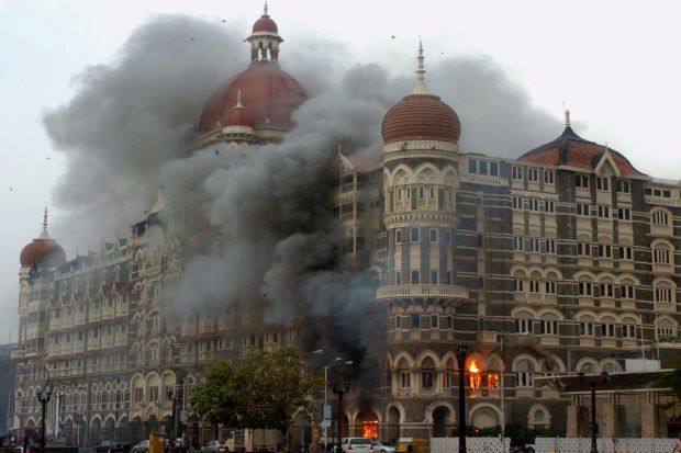 In this 29 Nov. 2008 file photo, smoke is seen billowing out of the ground and first floor of the Taj Hotel. (PTI)