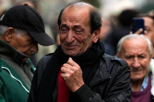 A man reacts by a memorial at the scene of Sunday's explosion on Istanbul's popular pedestrian Istiklal Avenue in Istanbul, Monday, Nov. 14, 2022. Turkey's interior minister says police have detained a suspect who is believed to have planted the bomb that exploded on a bustling pedestrian avenue in Istanbul. He said Monday that initial findings indicate that Kurdish militants were responsible for the attack. (Photo source: AP)