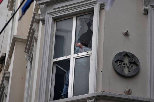 A man removes broken glass caused by Sunday's explosion on Istanbul's popular pedestrian Istiklal Avenue in Istanbul, Monday, Nov. 14, 2022. Turkey's interior minister says police have detained a suspect who is believed to have planted the bomb that exploded on a bustling pedestrian avenue in Istanbul. He said Monday that initial findings indicate that Kurdish militants were responsible for the attack. (Photo source: AP)