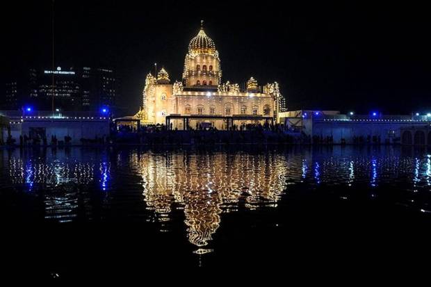 Gurudwara Bangla Sahib illuminated with lights on the eve of the birth anniversary of Guru Nanak Dev, in New Delhi. (Photo source: PTI)