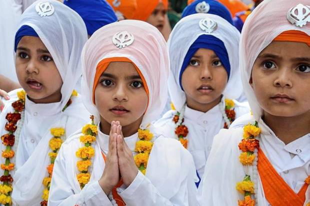 Children belonging to Sikh community and dressed as Panj Pyare's, participate in a 'nagar kirtan' (religious procession) on the eve of birth anniversary of Sikhism founder Guru Nanak Dev, at Golden Temple in Amritsar. (Photo source: PTI)