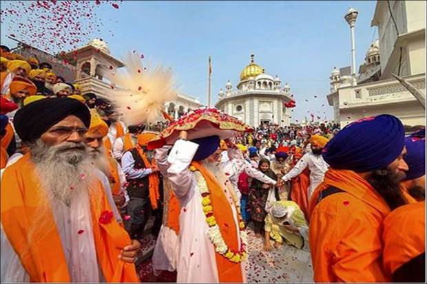 Sikh devotees participate in a 'nagar kirtan' (religious procession) on the eve of birth anniversary of Sikhism founder Guru Nanak Dev, at Golden Temple in Amritsar. (Photo source: PTI)