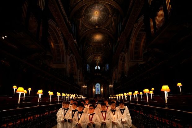 The Choristers of St Paul's pose as they prepare for the Christmas services in St Paul's Cathedral in London on Friday. (Image: AP)