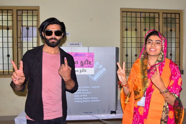 Cricketer Ravindra Jadeja with his wife and BJP candidate Rivaba Jadeja after casting his vote during the first phase of Gujarat Assembly elections in Jamnagar. (Image/PTI)