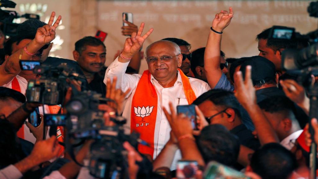 Chief Minister of Gujarat Bhupendra Patel gestures towards his supporters during celeberations by India's ruling Bharatiya Janata Party (BJP) after learning of the initial poll results of the state assembly election in Gandhinagar, India, December 8, 2022. REUTERS/Amit Dave
