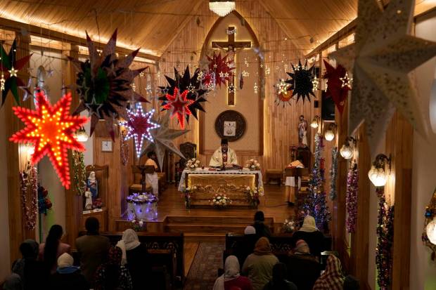 Kashmiri Christmas devotees pray inside the Holy Family Catholic church on Christmas in Srinagar. (AP Photo)