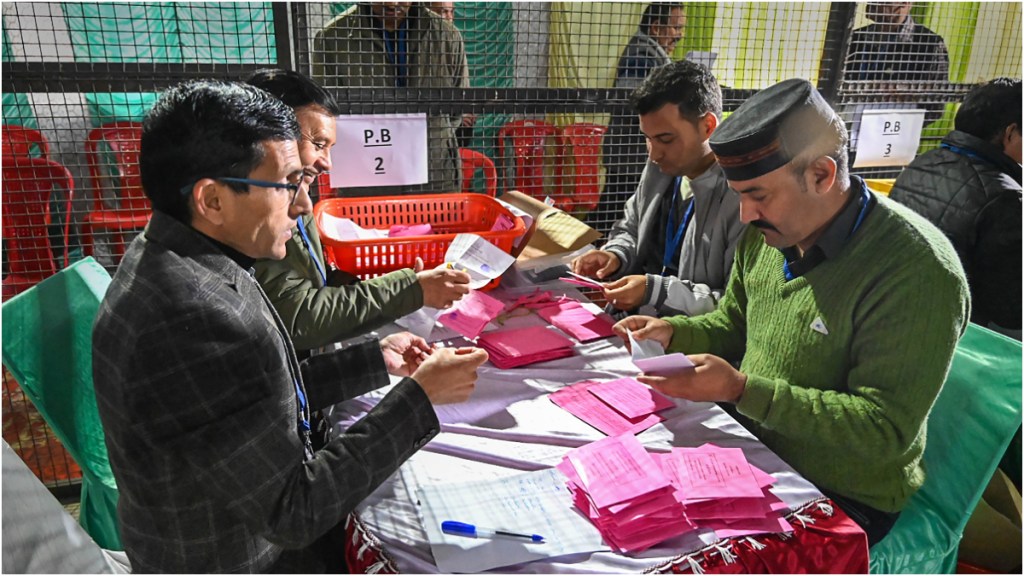 Poll officials count postal ballots for the Assembly elections at a centre in Mandi, Thursday, Dec. 8, 2022. (PTI Photo)