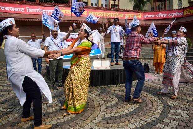 Aam Admi Party workers celebrate Delhi MCD election results at Shivaji Maharaj Chowk, Vashi in Navi Mumbai. (PTI Photo)