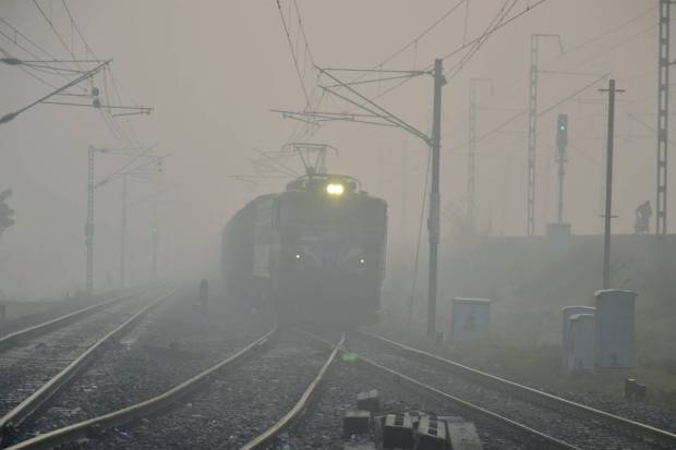 Mirzapur: A train runs through dense fog during a winter morning, in Mirzapur. (PTI Photo)