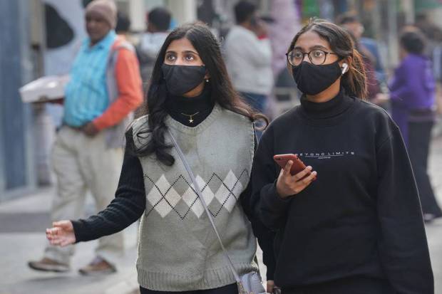 People wear face mask, at Khan Market in New Delhi.(PTI Photo)