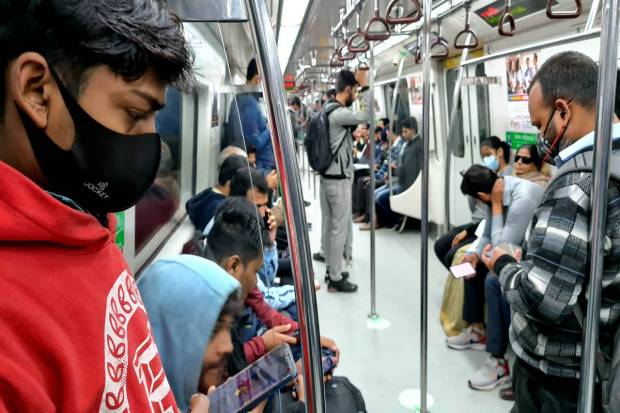 Commuters wearing face masks aboard a metro, amid a sudden spurt in COVID cases in China and some other countries, in New Delhi. (PTI Photo)