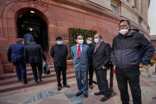 Officials at Parliament House complex wearing face masks, amid a sudden spurt in COVID cases in China and some other countries, in New Delhi.(PTI)