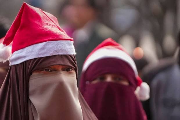 Srinagar: Muslim women participate in Christmas celebrations at the Holy Family Catholic Church, in Srinagar. (PTI Photo)