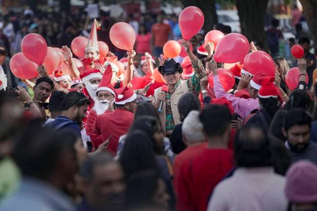 Mumbai: People celebrate Christmas at Marine Drive in Mumbai. (PTI Photo)