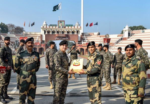 Border Security Force (BSF) Commandant Jasbir Singh presents sweets to Pakistani Rangers Wing Commander Aamir on the occasion of 74th Republic Day at the Attari-Wagah border, about 35 km from Amritsar on Thursday. (Image: PTI)