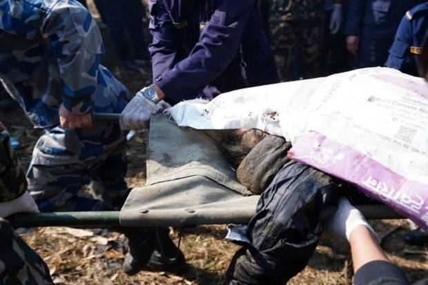 A body of a victim is carried away from the crash site of an aircraft carrying 72 people in Pokhara in western Nepal. REUTERS