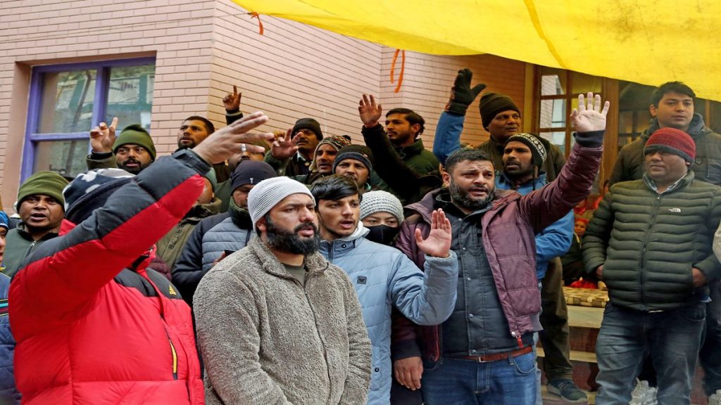 Locals shout slogans to protest against NTPC and the state government over cracks widening due to land subsidence at Joshimath, in Chamoli on Wednesday. (ANI Photo/Ayush Sharma)