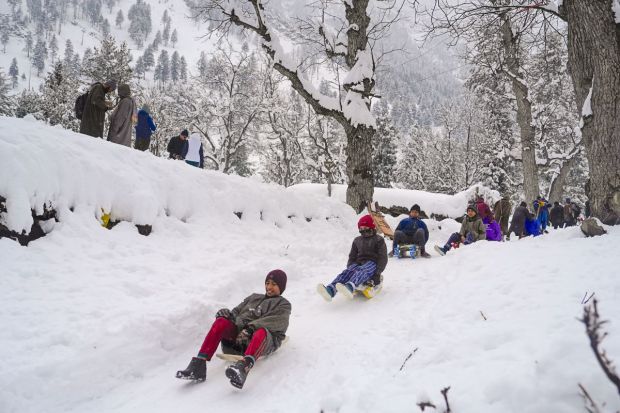 Children play during snowfall at Sonamarg in Ganderbal district of Kashmir. (Image: PTI)