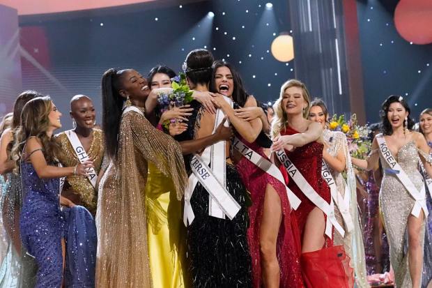 Miss USA R'Bonney Gabriel, back to camera, is hugged by other contestants after being crowned Miss Universe at the 71st Miss Universe pageant, in New Orleans on Saturday, Jan. 14, 2023. (AP Image)