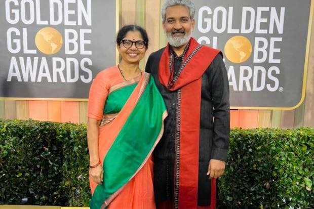 SS Rajamouli chose a traditional dhoti in red and black paired with a black kurta. He completed the look with a red stole which was embellished with tassels at the hem. His wife, Rama Rajamouli, kept it simple in an orange and sea green saree. (Twitter/@ssrajamouli)