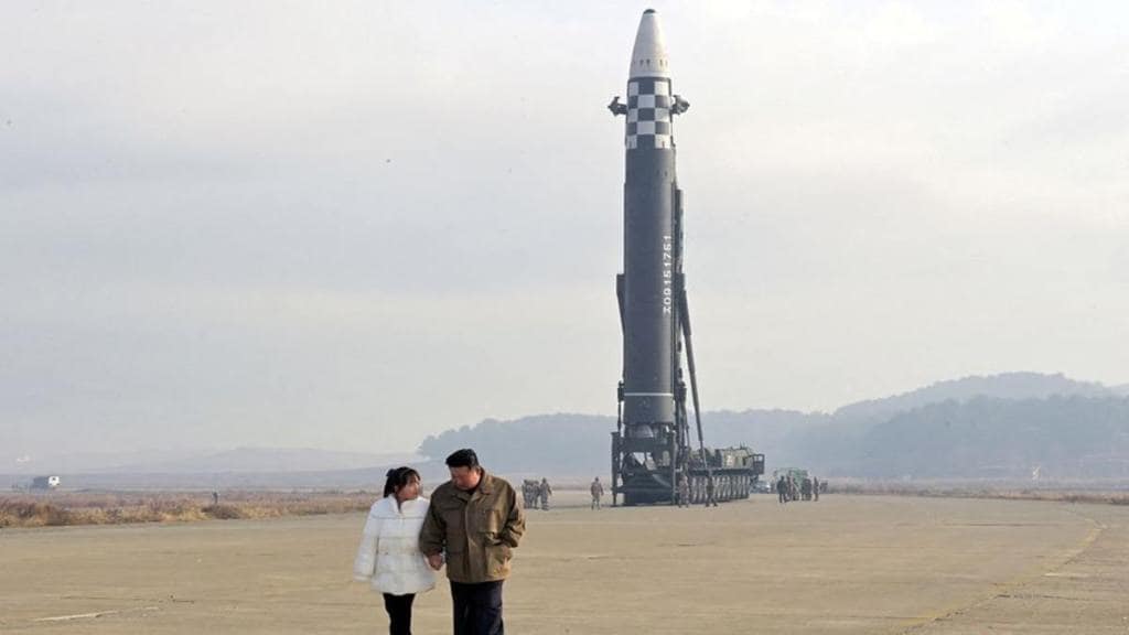 North Korean leader Kim Jong Un, along with his daughter, walks away from an intercontinental ballistic missile (ICBM) in this undated photo released on November 19, 2022 by North Korea's Korean Central News Agency (KCNA). KCNA via REUTERS