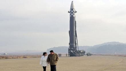 North Korean leader Kim Jong Un, along with his daughter, walks away from an intercontinental ballistic missile (ICBM) in this undated photo released on November 19, 2022 by North Korea's Korean Central News Agency (KCNA). KCNA via REUTERS