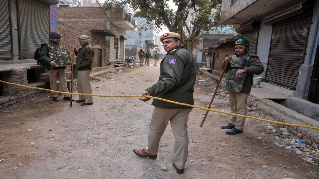 Delhi Police personnel deployed near the residence of the girl who was killed after being dragged by a car, at Karan Vihar area of Sultanpuri, in New Delhi, Tuesday, Jan. 3, 2023. (PTI Photo/Arun Sharma)