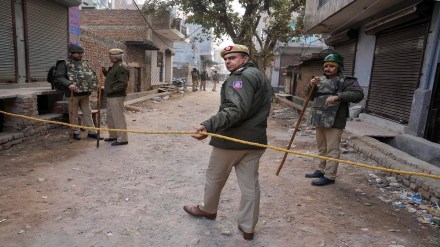 Delhi Police personnel deployed near the residence of the girl who was killed after being dragged by a car, at Karan Vihar area of Sultanpuri, in New Delhi, Tuesday, Jan. 3, 2023. (PTI Photo/Arun Sharma)
