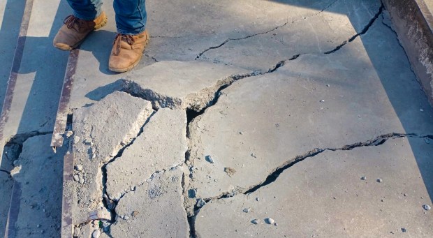 A man stands near cracks at his house in Joshimath of Chamoli district of Uttarakhand. (PTI Photo)