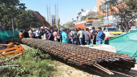People gather at the accident site where a half broken iron structure of a metro pillar fell, at Hennur Main Road in Bengaluru, Tuesday, Jan. 10, 2023. (PTI Photo)