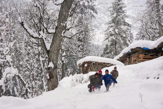 Sonamarg: Children play amid snowfall at Sonamarg in Ganderbal district of Kashmir, Thursday, Jan. 12, 2023. (PTI Photo)