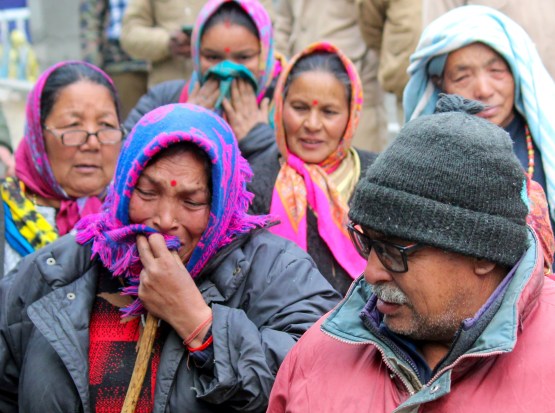 Hotel Malari Inn owner Thakur Singh Rana and his family members react ahead of its demolition, in Joshimath, Thursday, Jan. 12, 2023. (PTI Photo)