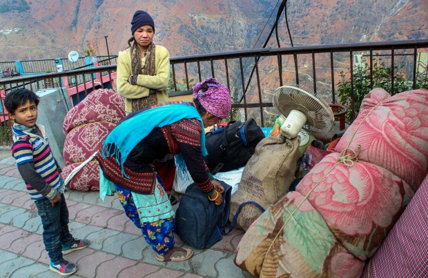 People shift with their belonging from an unsafe building in Joshimath, Thursday, Jan. 12, 2023. (PTI Photo)