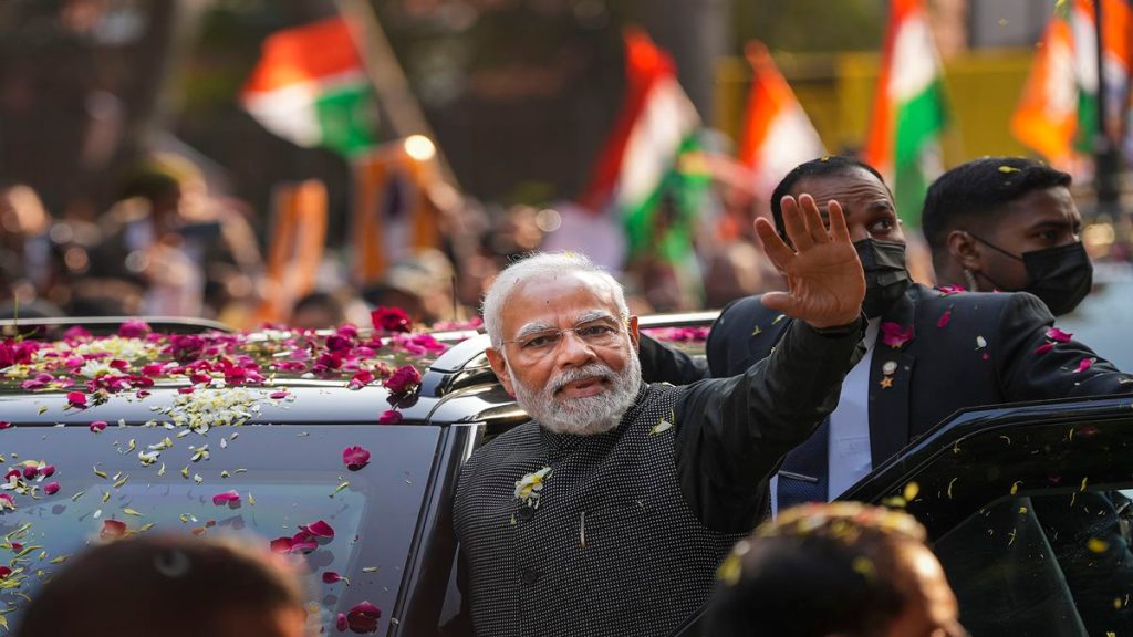 Prime Minister Narendra Modi waves at supporters during a roadshow, in New Delhi, Monday, Jan. 16, 2023. (PTI Photo/Ravi Choudhary)
