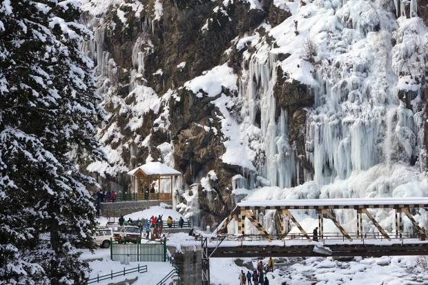 Tangmarg: Tourists visit a frozen waterfall at Drung area of Tangmarg in Baramulla district of north Kashmir. (PTI Photo)