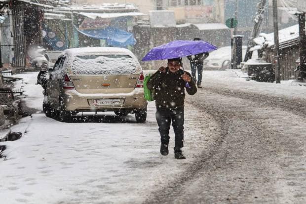 Joshimath: A commuter on a street amid heavy snowfall in Joshimath. (PTI Photo)