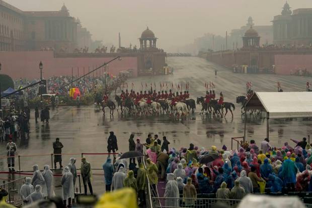 New Delhi: People wearing raincoats gather to watch the Beating Retreat ceremony, at Vijay Chowk in New Delhi. (PTI Photo)