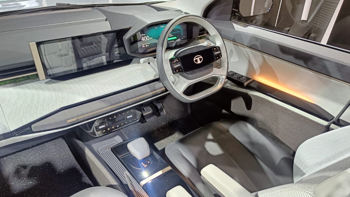 On the inside, the Tata Sierra EV gets a clean dashboard layout. It features a twin screen set-up, one for the infotainment system and the other for the instrument cluster. It also gets a four-spoke flat bottom steering wheel.
