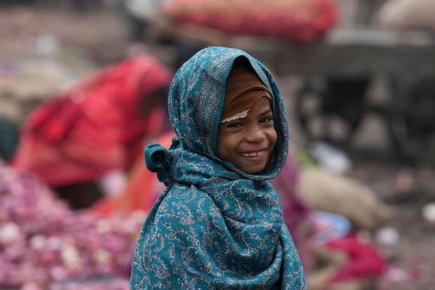 A child wrapped in woolens on a street during a cold winter morning, in New Delhi, (PTI Photo)
