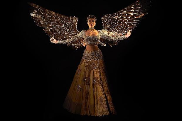 For the National Costume round, Rai wore an opulent golden ensemble and called it ‘Sone ki Chidiya'. The stunning outfit features intense gold metallic hand embellishments, daisy flowers and also very distinctive geometric divisions between the parts. (Instagram/missdivaorg)