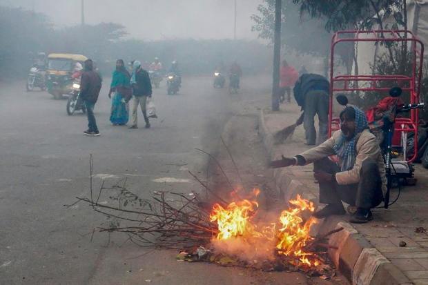 A dense layer of fog engulfed parts of north India including Delhi NCR. Visibility fell drastically and cars drove with their hazard lights on. Road traffic, train and flight schedules were heavily impacted. The city recorded a minimum temperature of 5 degrees Celsius on Monday. In several areas of the national capital, visibility was down to 25 metres early this morning.  (PTI Photo)