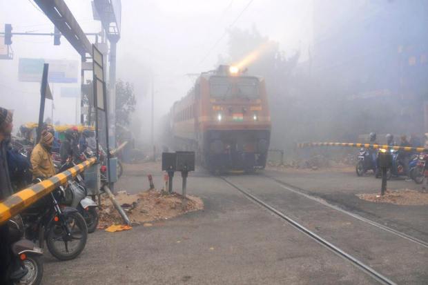 A train runs on its track amid low visibility due to a thick layer of fog on a cold winter morning (PTI Photo)