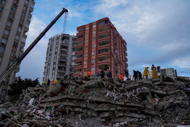 People and emergency teams search for people in a destroyed building in Adana, Turkey, Monday, Feb. 6, 2023. A powerful quake has knocked down multiple buildings in southeast Turkey and Syria and many casualties are feared. (Photo/AP)