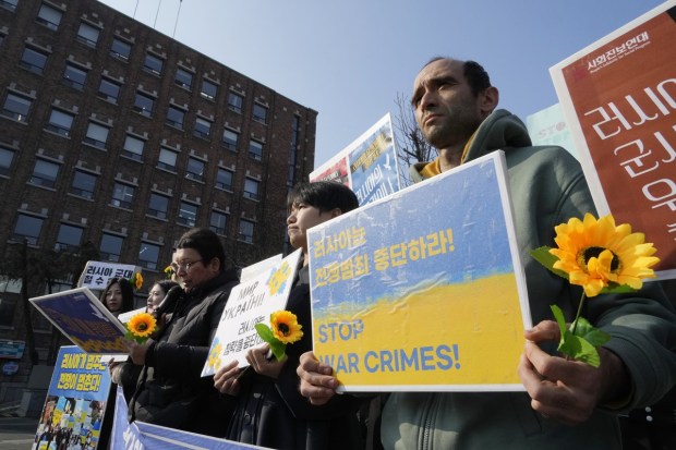 Protesters attend a rally to mark the one-year anniversary of Russia's invasion of Ukraine, near the Russian Embassy in Seoul, South Korea. (AP Photo)