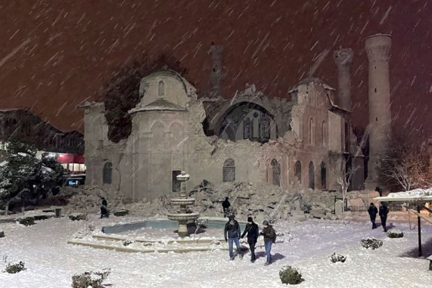 People walk next to a mosque destroyed by an earthquake in Malatya, Turkey, Monday, Feb. 6, 2023. A powerful quake has knocked down multiple buildings in southeast Turkey and Syria and many casualties are feared. (Photo/AP)