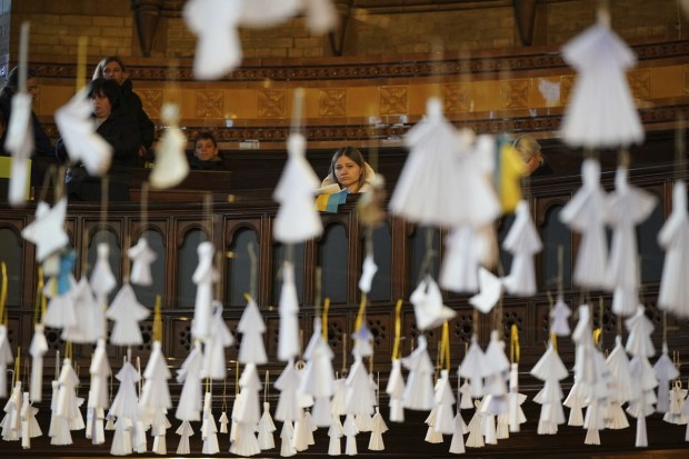 461 paper angels hang from the roof of the cathedral, one for each child that has died in the past year. (AP photo)