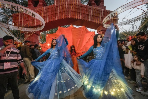 Artists perform during a parade at the 36th Surajkund International Crafts Mela. (PTI photo)