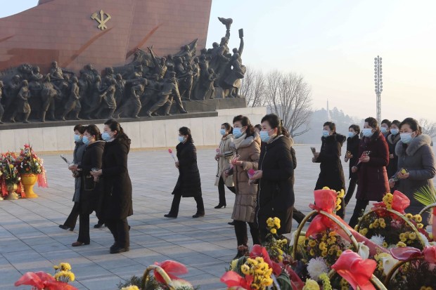 Residents in Pyongyang marked the anniversary by visiting the city’s Mansu Hill to lay flowers and pay respect to the statues of their late leaders, Kim Il Sung and Kim Jong Il, respectively the grandfather and father of their ruler, as soldiers lined up to salute. (AP Photo)