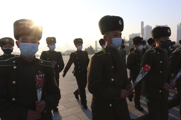 Public Security Forces soldiers visit Mansu Hill to pay respect to the statues of their late leaders Kim Il Sung and Kim Jong Il on the occasion of the 75th founding anniversary of the Korean People's Army. (AP Photo)